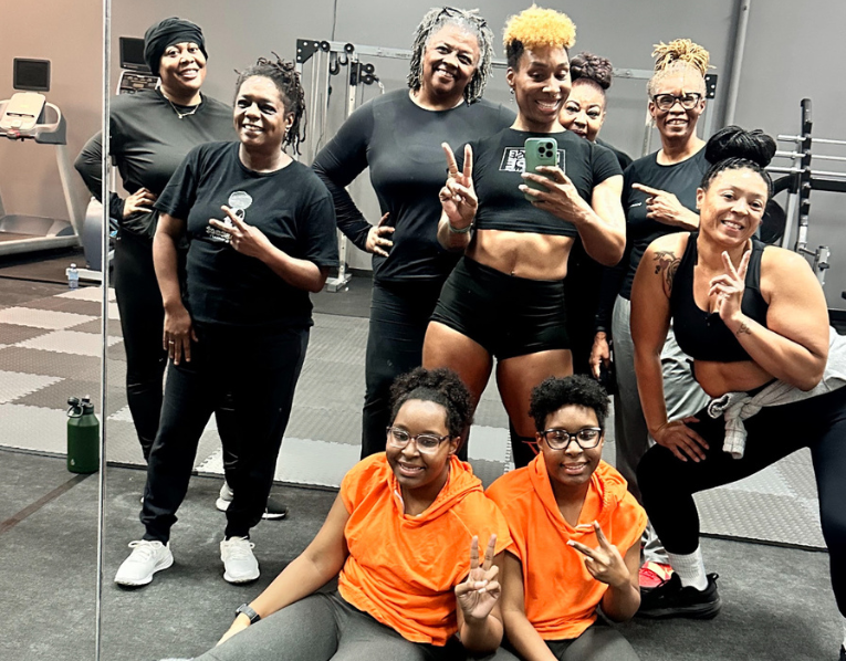 ReleaseHER Fit Club group posing together in the gym